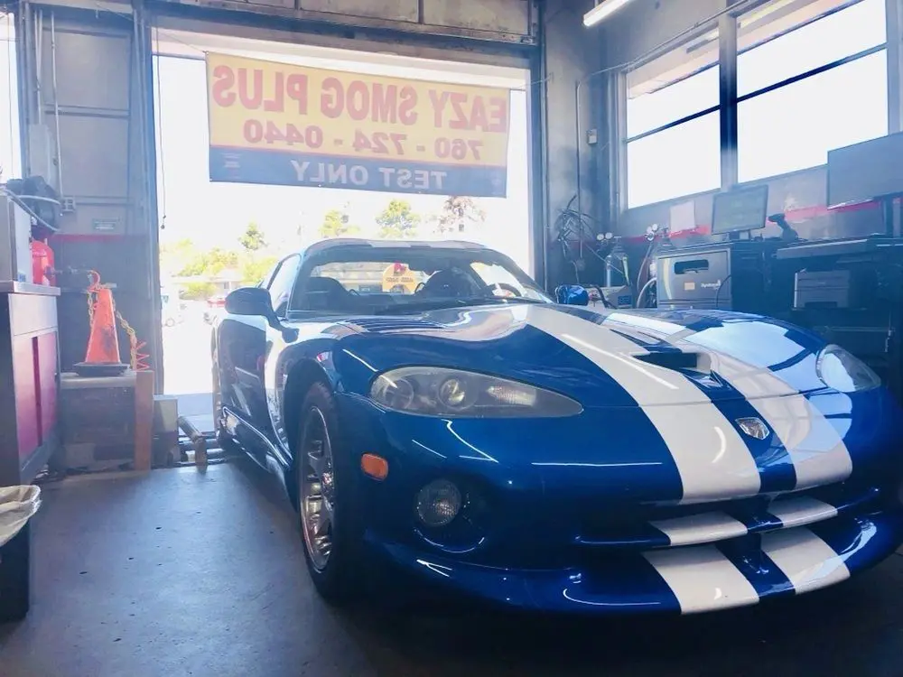 A blue and white car in a garage.