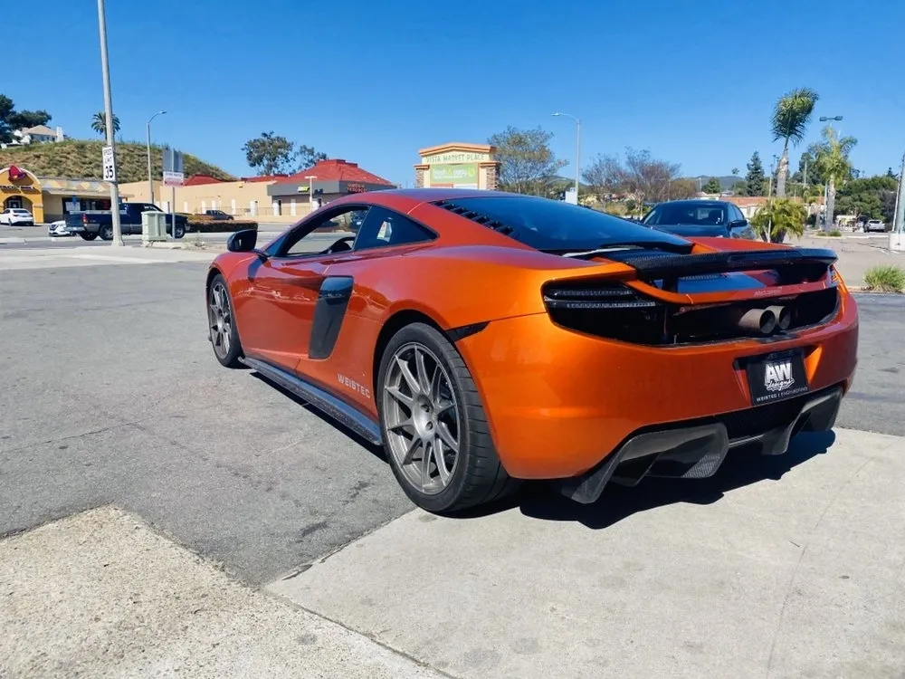 A mclaren sports car parked on the side of a road.