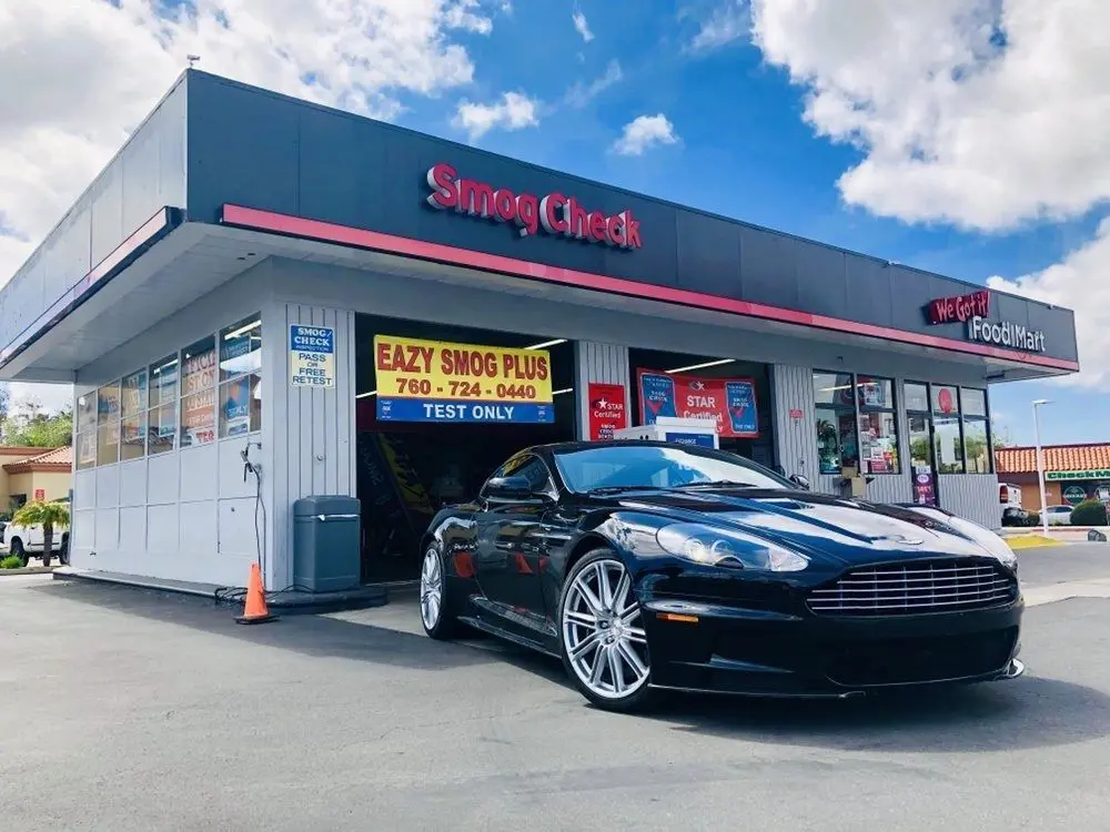 A black car parked in front of a store.